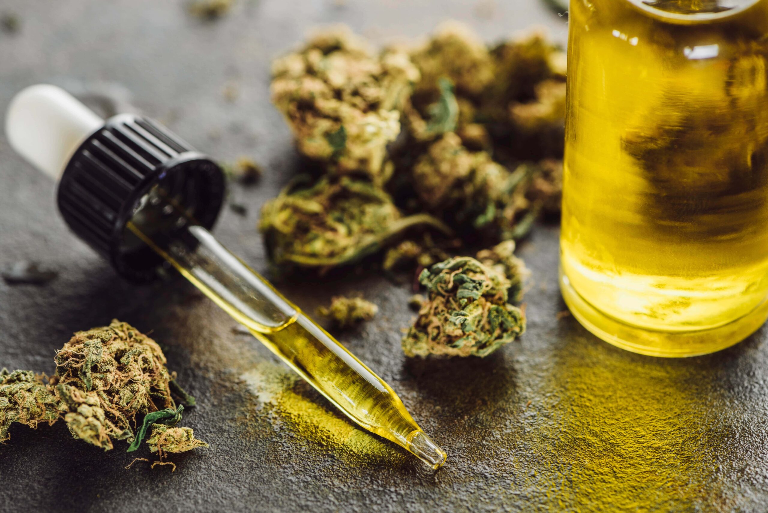 CBD flower beside oil bottle and dropper